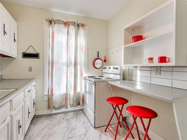 kitchen featuring backsplash, white cabinetry, a breakfast bar, and white electric stove