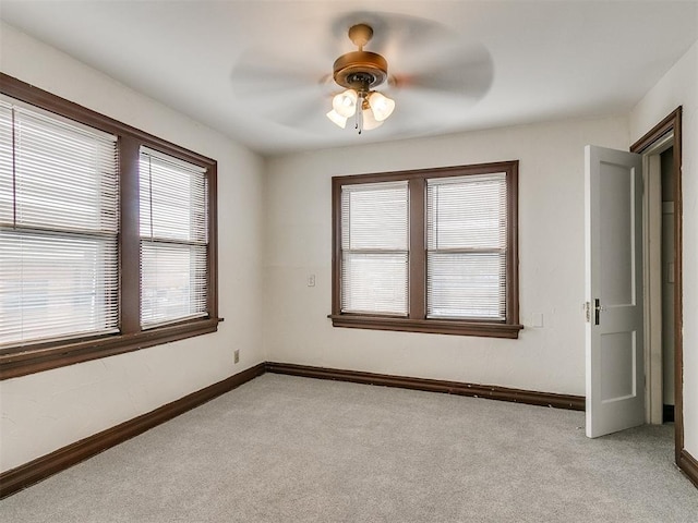 empty room with light carpet, plenty of natural light, and ceiling fan