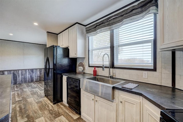 kitchen with wood-type flooring, sink, tasteful backsplash, and black appliances