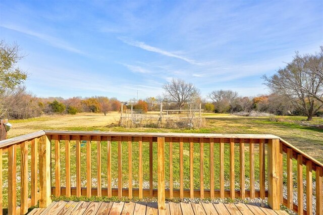 wooden deck featuring a lawn