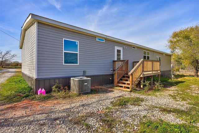 back of property with cooling unit and a deck