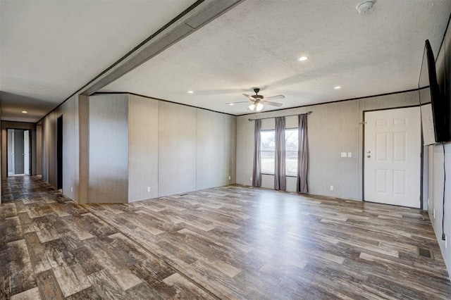 empty room with hardwood / wood-style floors, a textured ceiling, and ceiling fan