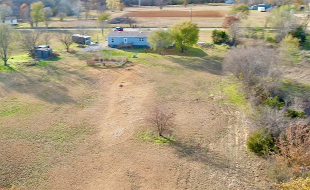 birds eye view of property with a rural view