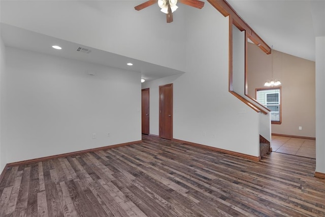 unfurnished living room featuring ceiling fan with notable chandelier, beam ceiling, dark hardwood / wood-style flooring, and high vaulted ceiling