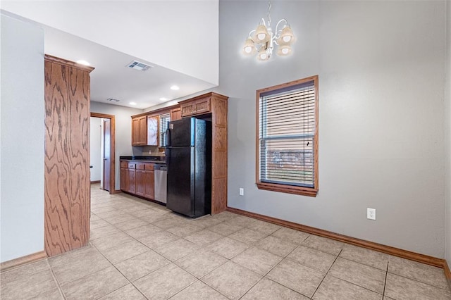 kitchen featuring dishwasher, black refrigerator, light tile patterned floors, and a chandelier