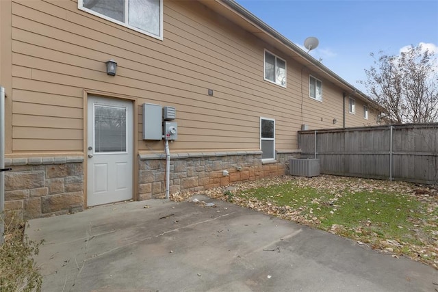 view of property exterior featuring a yard, central AC, and a patio area