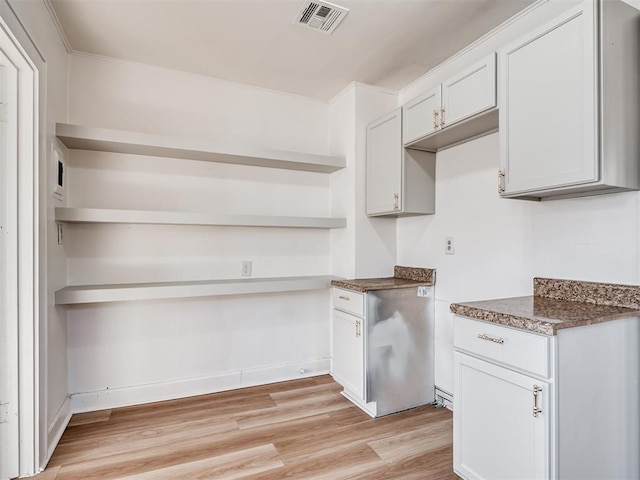 kitchen featuring light wood-type flooring, white cabinetry, and crown molding