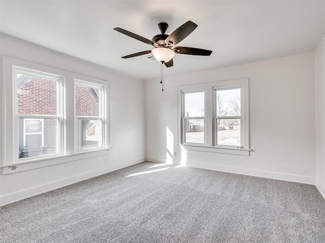 spare room featuring ceiling fan, carpet floors, and a wealth of natural light