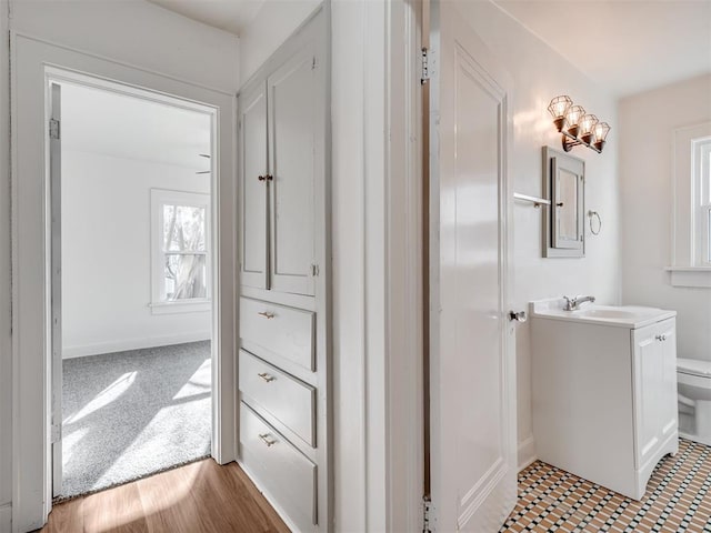 bathroom featuring tile patterned floors, vanity, and toilet