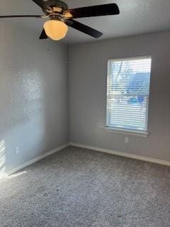 carpeted spare room with ceiling fan