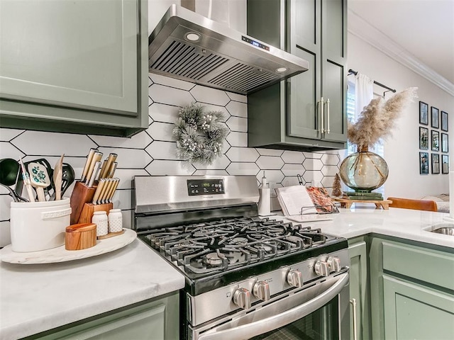 kitchen featuring gas range, extractor fan, and green cabinetry