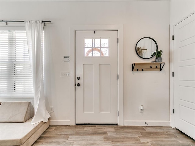 entryway with light wood-style floors and baseboards