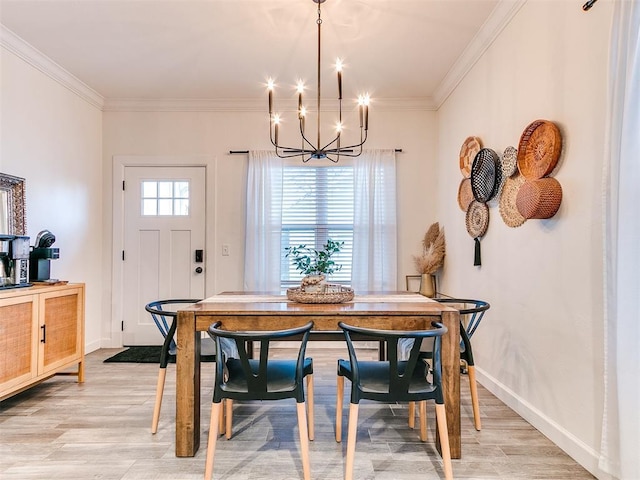 dining area with a healthy amount of sunlight, ornamental molding, and a notable chandelier