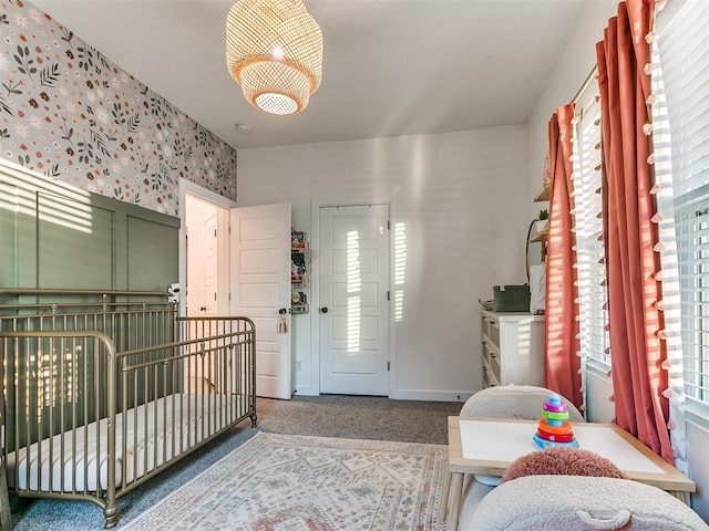 bedroom with wallpapered walls, baseboards, and carpet flooring