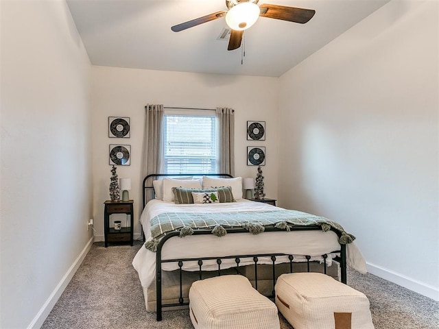 bedroom with light carpet, ceiling fan, and baseboards