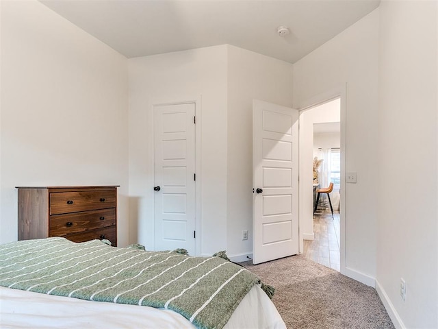 bedroom featuring carpet floors and baseboards