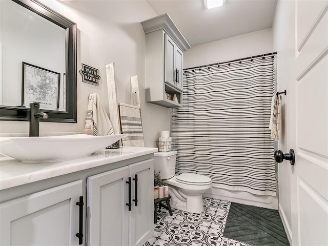 bathroom featuring toilet, tile patterned flooring, and vanity