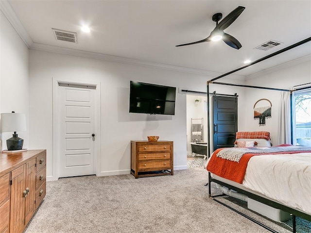 bedroom with light carpet, a barn door, ornamental molding, and visible vents