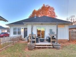 back of house featuring fence