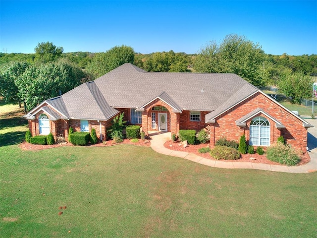 single story home featuring a front yard