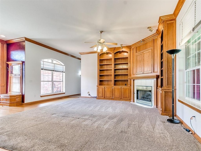 826 S Mustang Rd, Tuttle, OK 73089 - unfurnished living room featuring ornamental molding, ceiling fan, built in features, a fireplace, and light colored carpet