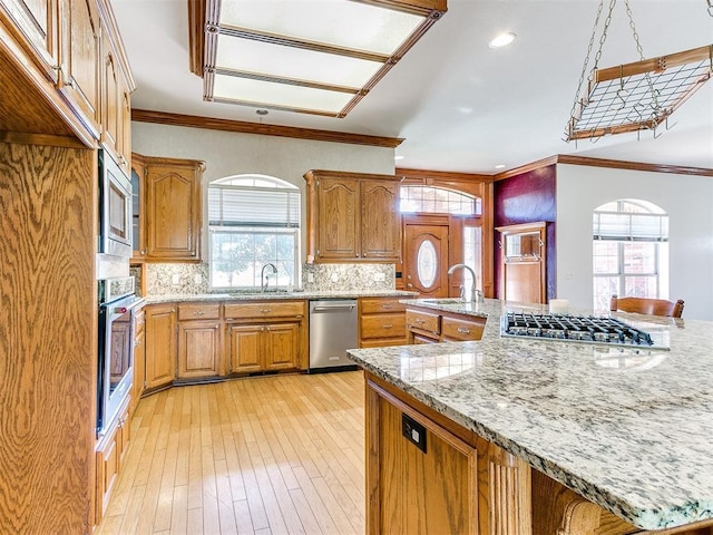 826 S Mustang Rd, Tuttle, OK 73089 - kitchen with stainless steel appliances, healthy amount of natural light, backsplash, ornamental molding, and recessed lighting