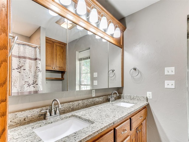 826 S Mustang Rd, Tuttle, OK 73089 - full bathroom featuring double vanity and a textured wall