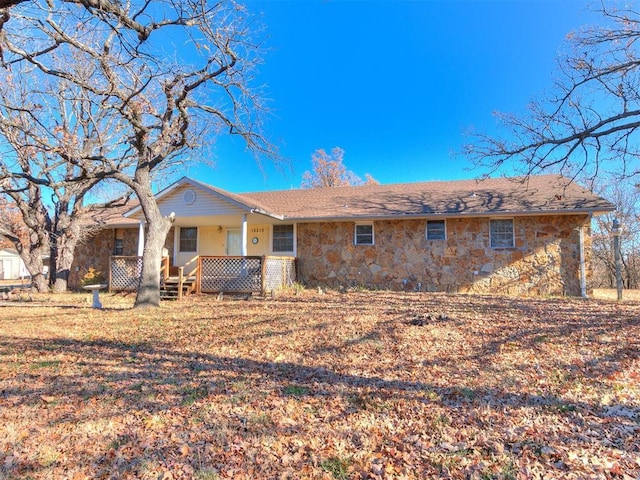 rear view of property featuring covered porch