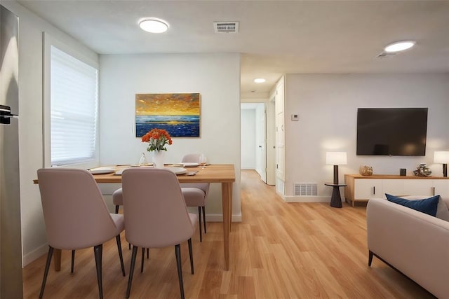 dining space featuring light wood-type flooring