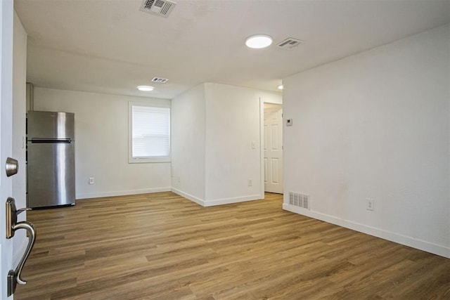 unfurnished room with light hardwood / wood-style flooring