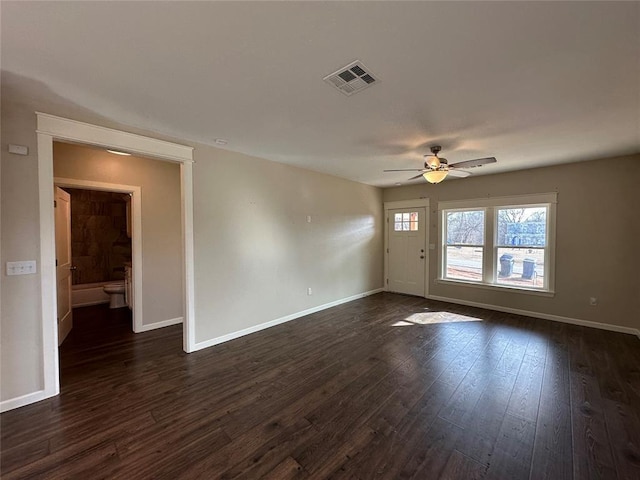 spare room with ceiling fan and dark hardwood / wood-style floors