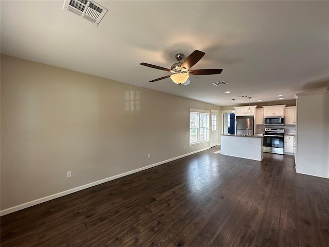 unfurnished living room featuring dark wood-type flooring and ceiling fan