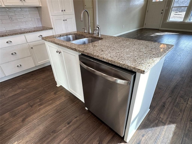 kitchen with white cabinetry, stainless steel dishwasher, sink, and an island with sink