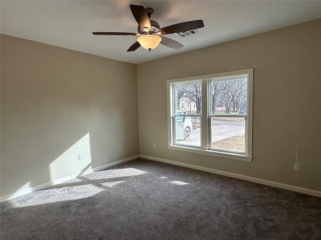 carpeted spare room with ceiling fan