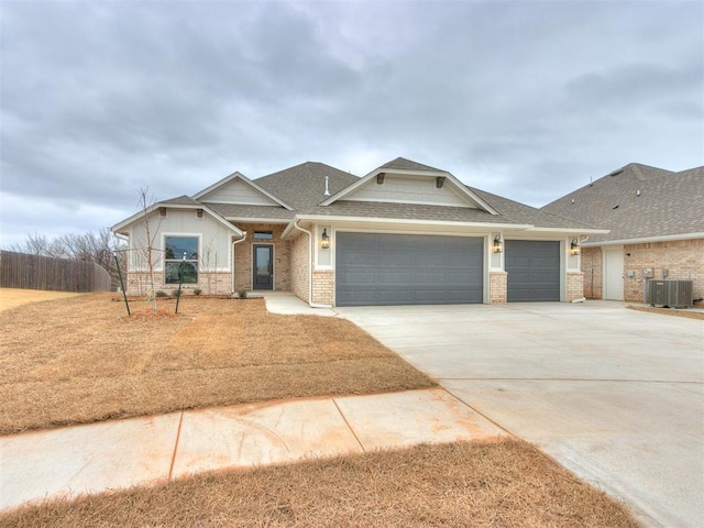 craftsman-style home with central AC unit and a garage