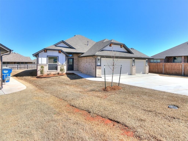 view of front of home with an attached garage, fence, driveway, and a shingled roof