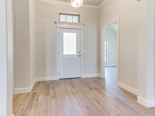 entryway featuring baseboards, light wood-style flooring, and ornamental molding