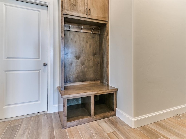 mudroom featuring baseboards and wood finished floors