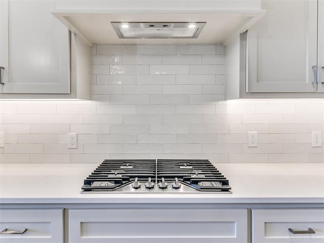 kitchen with tasteful backsplash, light countertops, and stainless steel gas cooktop