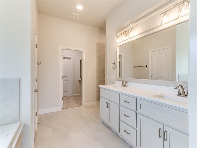 full bathroom featuring double vanity, baseboards, visible vents, and a sink