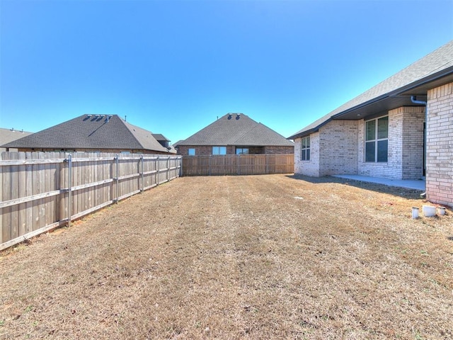 view of yard with a fenced backyard