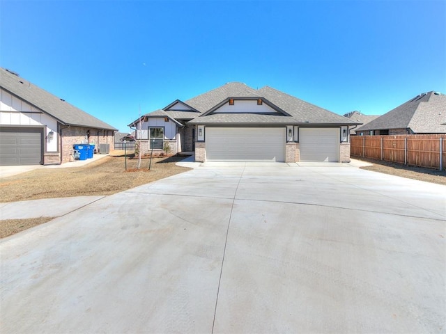 view of front facade with fence, concrete driveway, an attached garage, a shingled roof, and brick siding