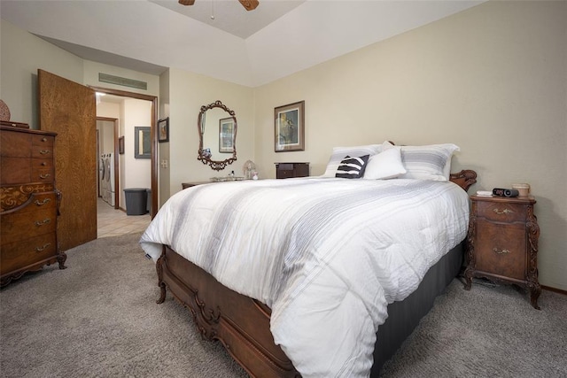 bedroom featuring ceiling fan, light colored carpet, and washer / dryer