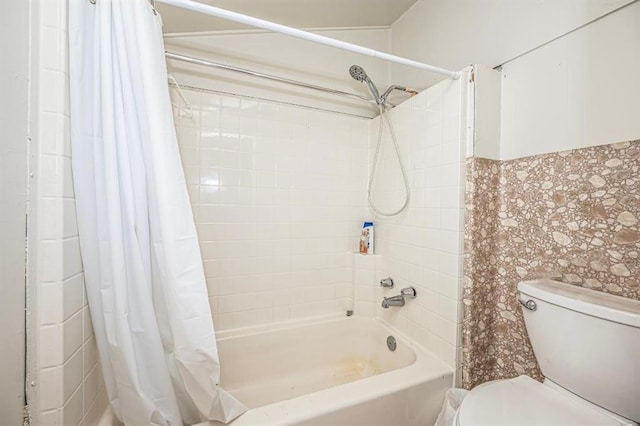 bathroom featuring shower / tub combo and toilet