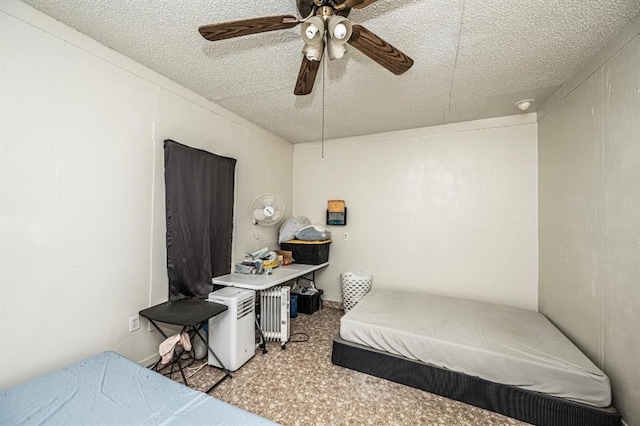 bedroom featuring ceiling fan, carpet floors, a textured ceiling, and radiator