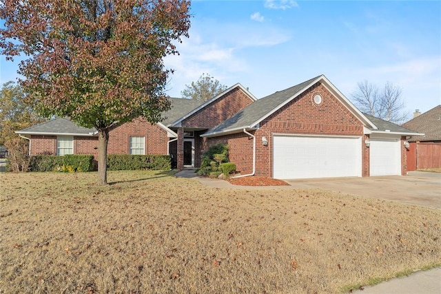 single story home featuring a garage and a front yard