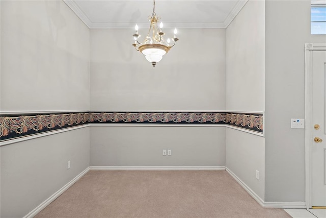 carpeted empty room featuring a chandelier and ornamental molding