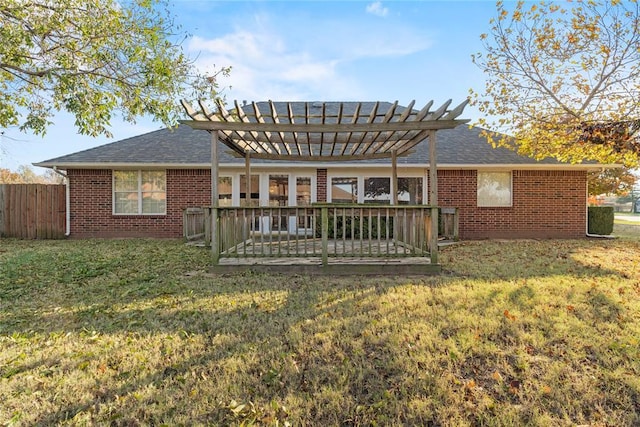 back of house featuring a lawn, a pergola, and a wooden deck