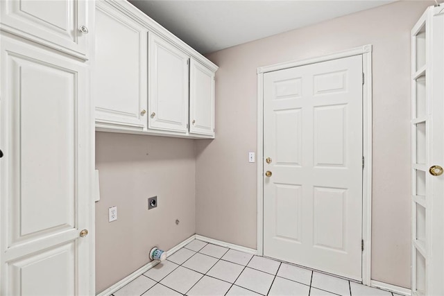 laundry area with cabinets, light tile patterned floors, and electric dryer hookup