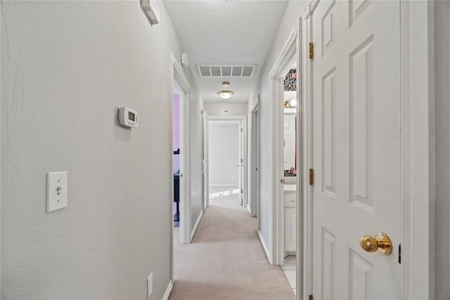 hallway featuring light carpet